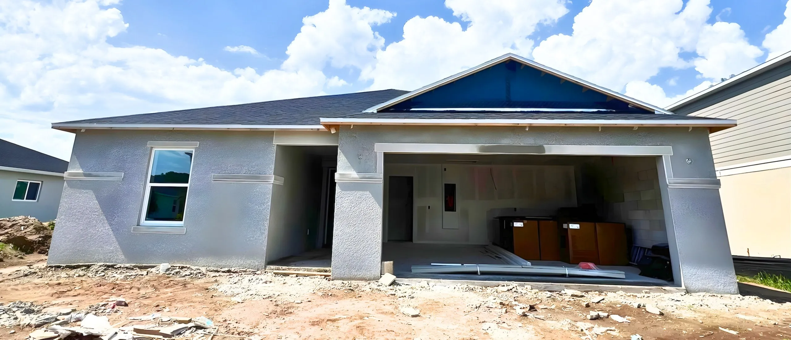 Florida home exterior before painting, unfinished gray stucco