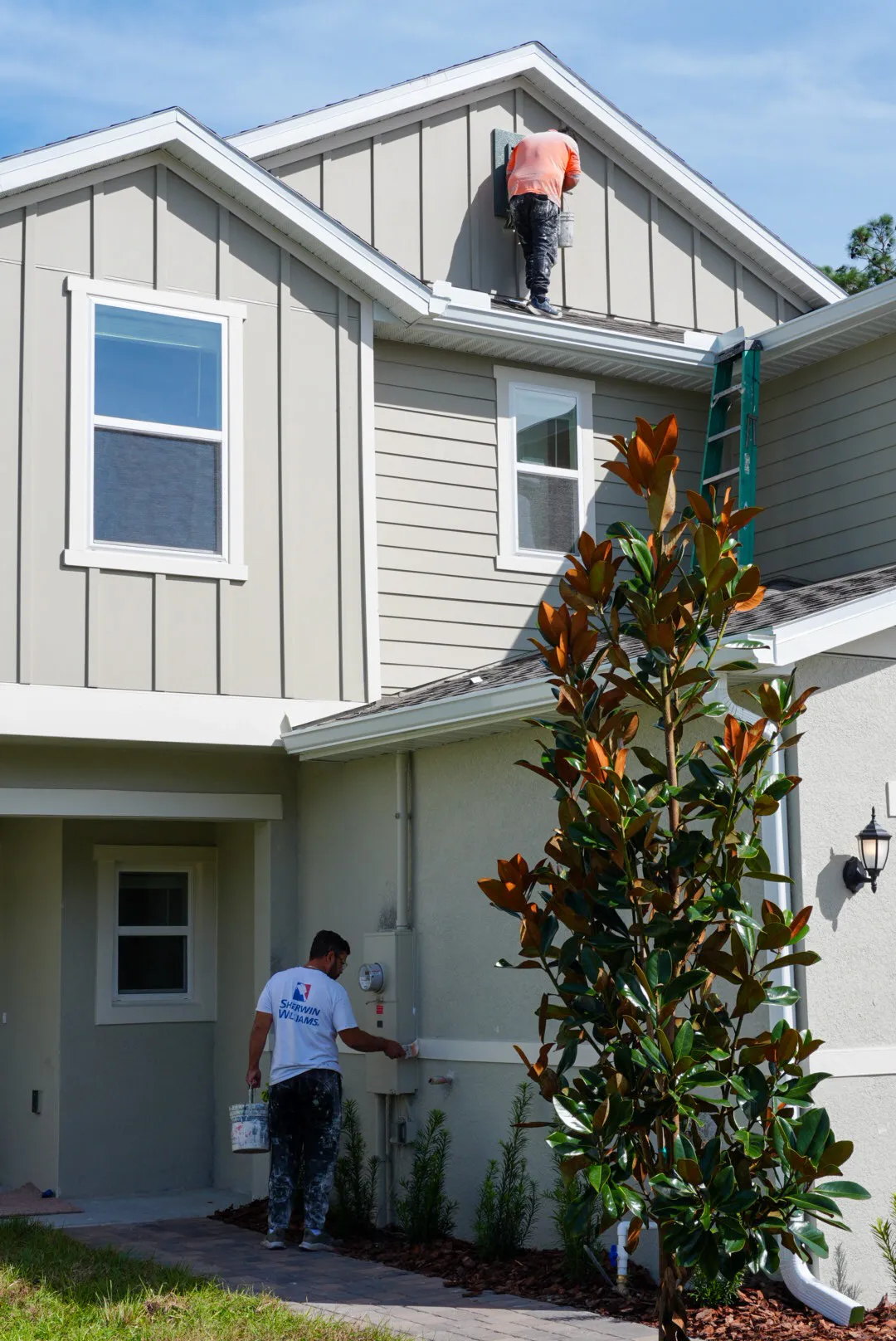 Glades Pro crew painting a townhome exterior